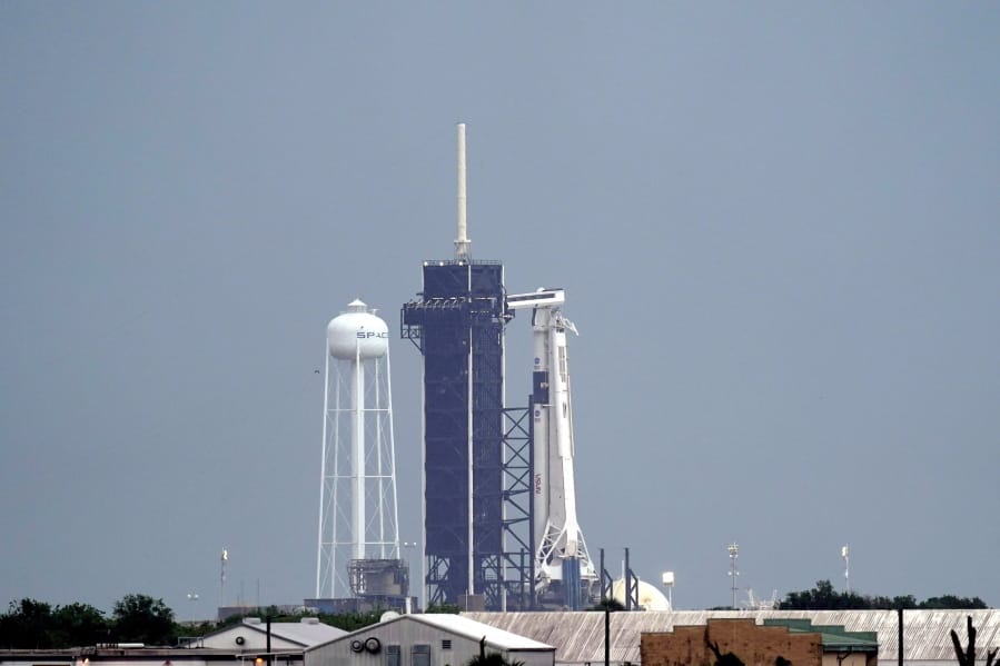 The SpaceX Falcon 9, with the Crew Dragon spacecraft on top of the rocket, sits on Launch Pad 39-A Wednesday, May 27, 2020, at Kennedy Space Center in Cape Canaveral, Fla. Two astronauts will fly on the SpaceX Demo-2 mission to the International Space Station scheduled for launch Wednesday afternoon. (AP Photo/David J.