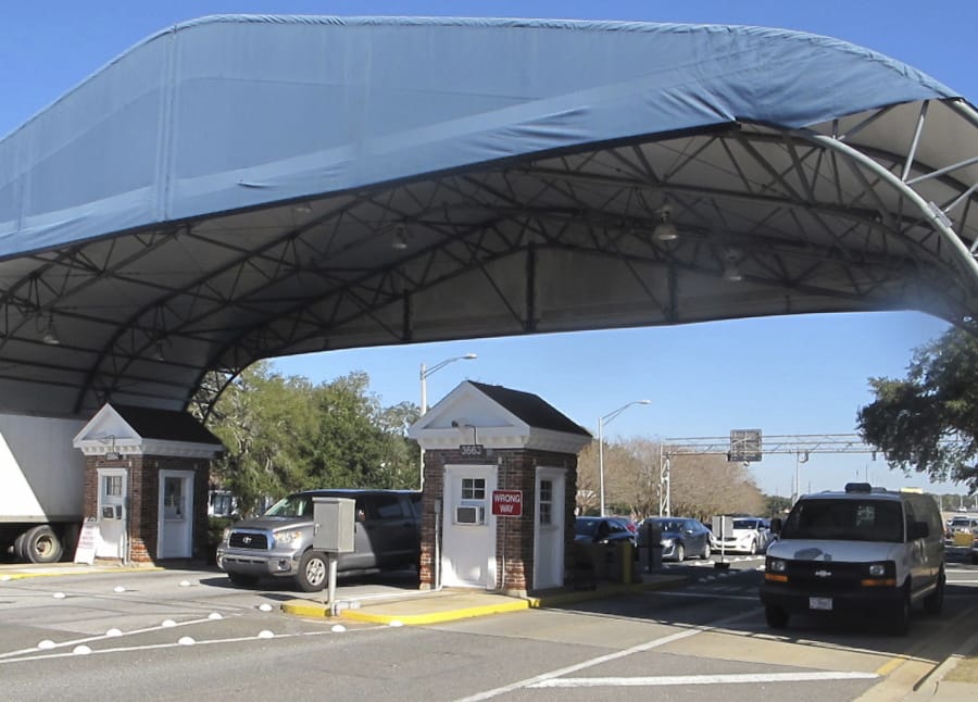 FILE- In this Jan. 29, 2016 file photo shows the entrance to the Naval Air Base Station in Pensacola, Fla. The FBI has found a link between the gunman in a deadly attack at a military base last December and an al-Qaida operative. That&#039;s according to a U.S. official who spoke to The Associated Press on Monday.