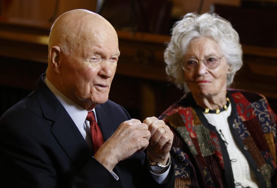 FILE - In this May 14, 2015, file photo, former astronaut and U.S. Sen. John Glenn, D-Ohio, left, answers questions with his wife Annie Glenn during an interview with The Associated Press at the Ohio Statehouse in Columbus, Ohio. Glenn, the widow of John Glenn and a communication disorders advocate, died Tuesday, May 19, 2020, of COVID-19 complications at a nursing home near St. Paul, Minn., at age 100.