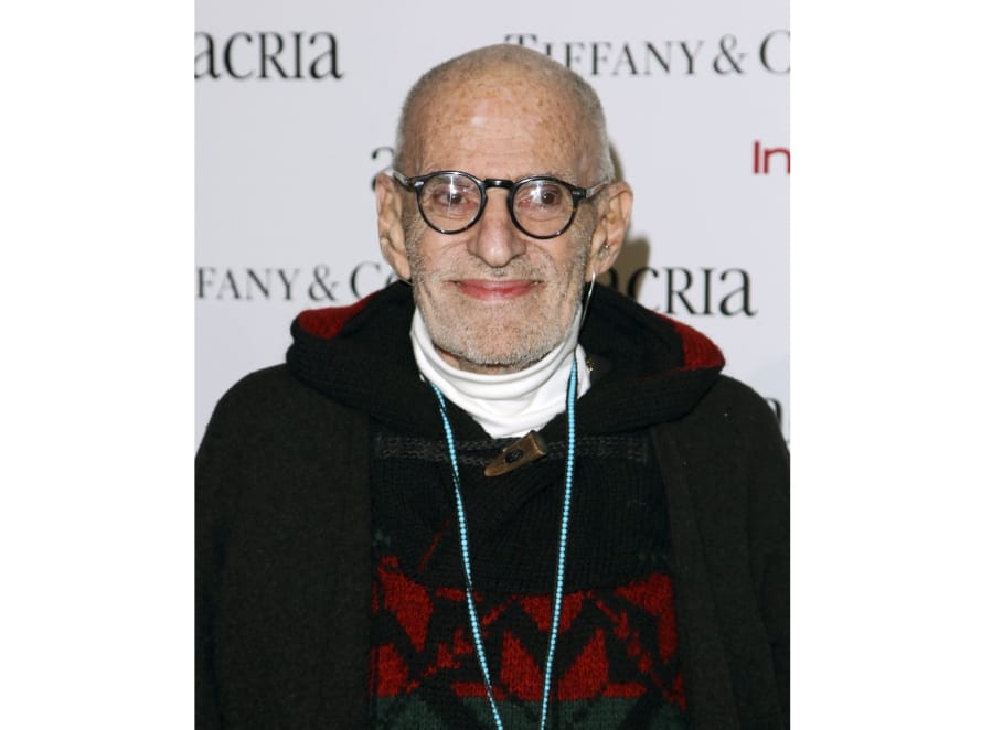 FILE - In this Dec. 10, 2014 file photo, playwright Larry Kramer attends Acria&#039;s 19th Annual Holiday Dinner Benefit in New York. Kramer, the playwright whose angry voice and pen raised theatergoers&#039; consciousness about AIDS and roused thousands to militant protests in the early years of the epidemic, died Wednesday, May 27, 2020 in Manhattan of pneumonia. He was 84.