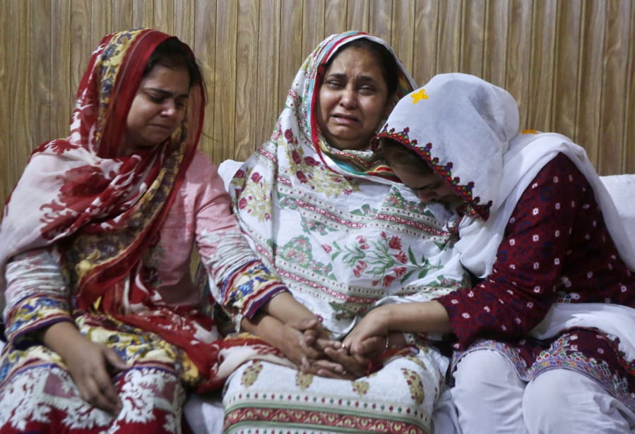 Family members of an air hostess Anam Maqsood, who was killed in Friday&#039;s plane crash, mourn for her death at their home in Lahore, Pakistan, Saturday, May 23, 2020. An aviation official says a passenger plane belonging to state-run Pakistan International Airlines carrying passengers and crew has crashed near the southern port city of Karachi. (AP Photo/K.M.