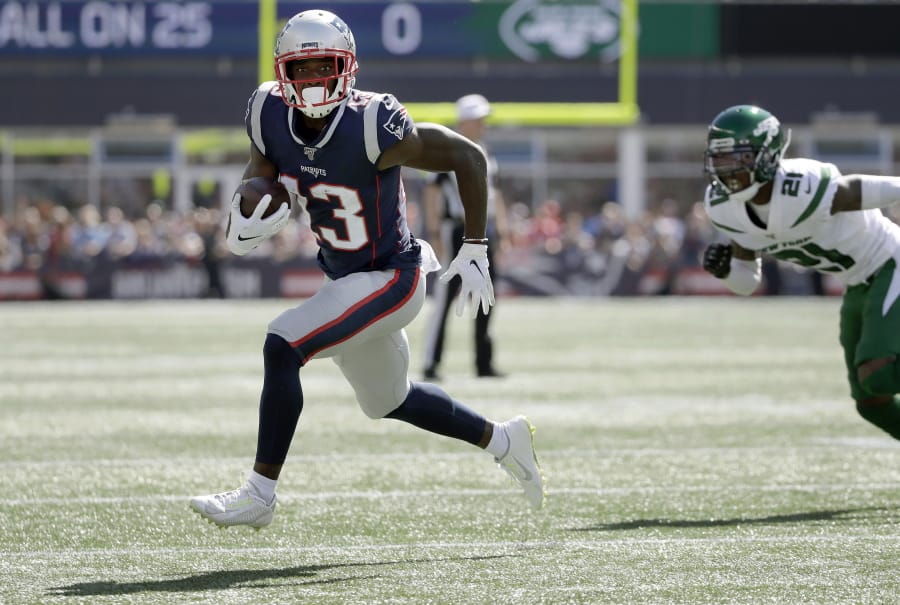 FILE - In this Sept. 22, 2019, file photo, New England Patriots wide receiver Phillip Dorsett, left, runs from New York Jets cornerback Nate Hairston (21) on the way for a touchdown after a reception during an NFL football game in Foxborough, Mass. Dorsett has never set foot in Seattle or anywhere in the Pacific Northwest. Not as a player in either of his previous NFL stops. Not in college. Not just for a random trip. He hasn&#039;t even seen in person the the place he&#039;ll practice after signing with the Seattle Seahawks whenever the facility becomes available to use.