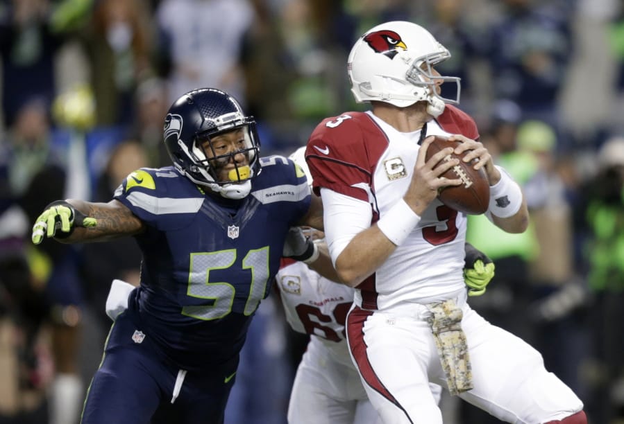 FILE - In this Nov. 15, 2015, file photo, Seattle Seahawks outside linebacker Bruce Irvin (51) pressures Arizona Cardinals quarterback Carson Palmer during the first half of an NFL football game in Seattle. Irvin is thrilled to be back where his NFL journey started. Irvin jumped at the chance to return to Seattle this offseason, but his reunion with the Seahawks comes with the expectation he can help a lackluster pass rush.