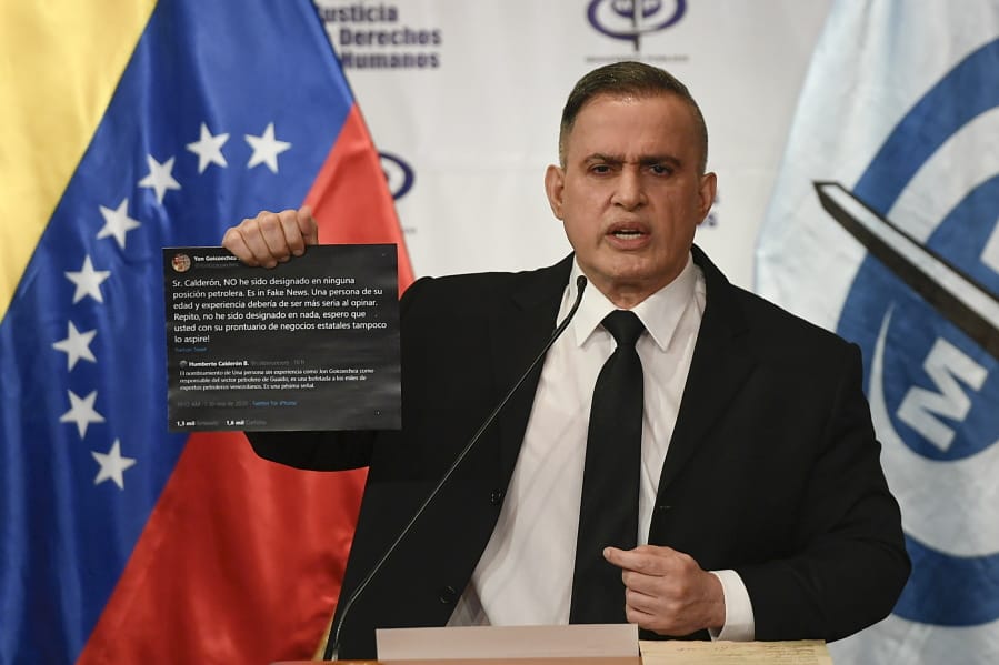 Venezuela&#039;s Attorney General Tarek William Saab holds up twitter posts during a press conference regarding what the government calls a failed attack over the weekend aimed at overthrowing President Nicolas Maduro in Caracas, Venezuela, Monday, May 4, 2020. The twitter posts are between two members of the opposition, Humberto Calderon and Yon Goicoechea.