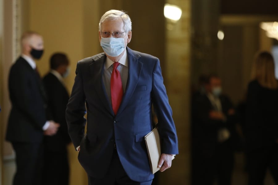Senate Majority Leader Mitch McConnell of Ky., wears a face mask to protect against the spread of the new coronavirus as he walks to the Senate chamber after meeting with Vice President Mike Pence and Treasury Secretary Steve Mnuchin on Capitol Hill in Washington, Tuesday, May 19, 2020.