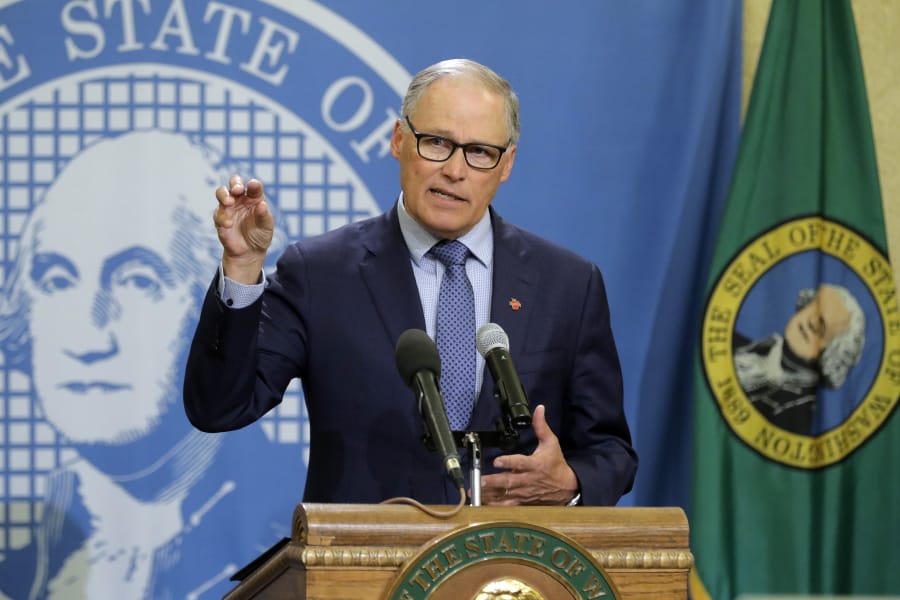 FILE - In this Monday, April 13, 2020, file photo, Washington Gov. Jay Inslee speaks during a news conference at the Capitol in Olympia, Wash. Inslee has repeatedly said he will rely on scientific models and input from state health officials to determine when stay-at-home orders can be relaxed, despite growing calls for them to be ended, including a protest that drew about 2,500 to the state Capitol. (AP Photo/Ted S.