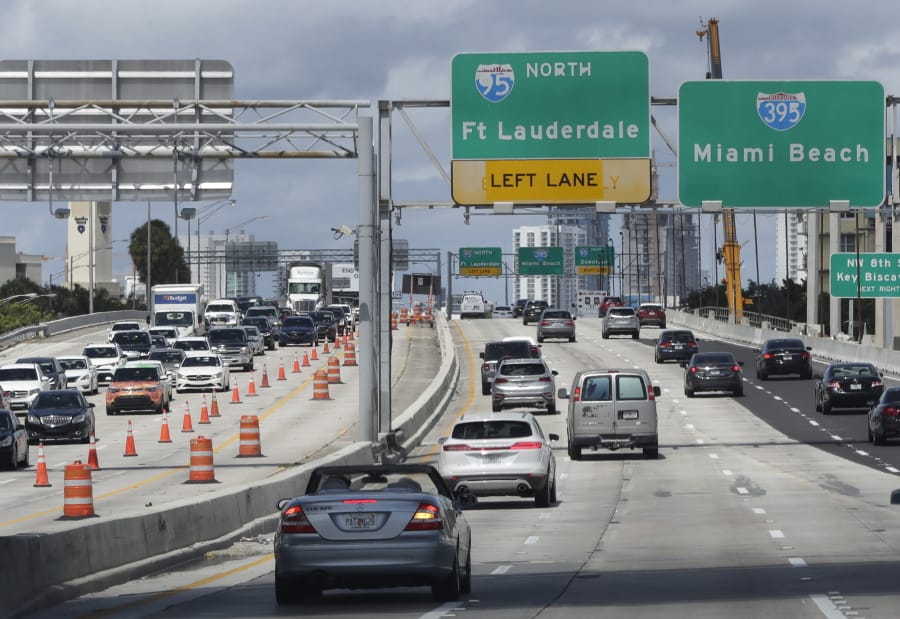 Cars travel along the Dolphin Expressway, Monday, May 11, 2020, in downtown Miami. Americans are slowly getting back on the road after hunkering down amid the cornonavirus pandemic, though driving still is well below what it was before many states issued stay-at-home orders.
