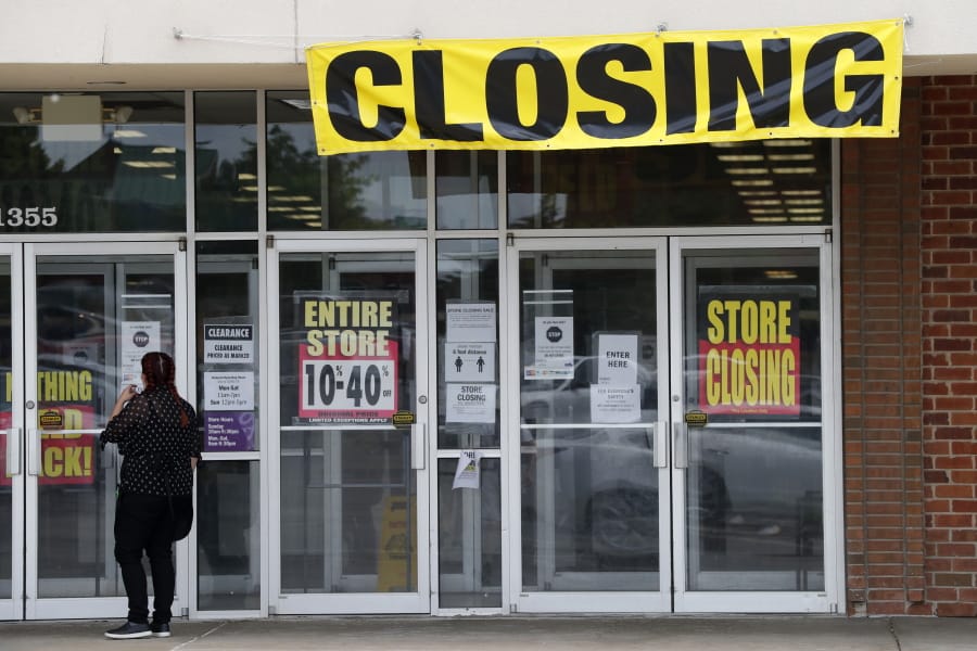 A woman walks into a closing Gordmans store, Thursday, May 28, 2020, in St. Charles, Mo. Stage Stores, which owns Gordmans, is closing all its stores and has filed for Chapter 11 bankruptcy.