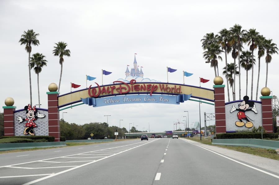 The road to the entrance of Walt Disney World has few cars Monday, March 16, 2020, in Lake Buena Vista, Fla. The Magic Kingdom, Epcot and Hollywood Studios were closed along with other theme parks around the state to help curb the spread of the coronavirus.