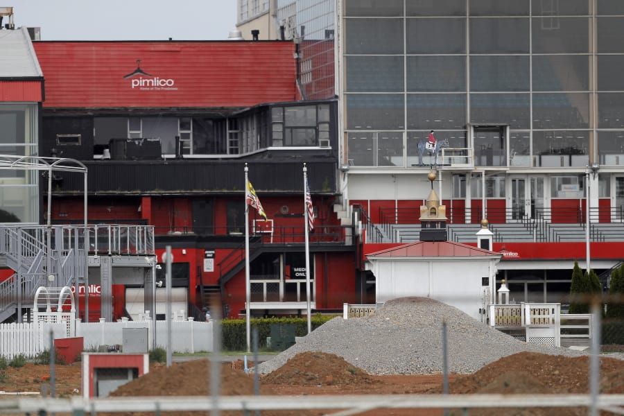 The grandstand near the finish line at Pimlico Race Course is seen empty, Friday, May 15, 2020, in Baltimore. The Preakness would have been run Saturday, May 16, 2020, in Baltimore. But Pimlico Race Course and many tracks across North America remain dark because of the coronavirus pandemic.