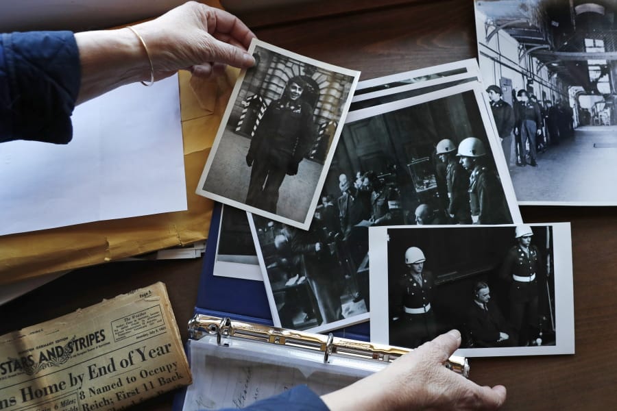 Emily DiPalma Aho looks over photographs and memorabilia of her father, Emilio DiPalma, a World War II veteran, at her home in Jaffrey, N.H., Wednesday, May 13, 2020. Emilio, who as a 19-year-old U.S. Army infantryman stood guard at the Nuremberg Nazi war crimes trials, died last month at the age of 93 after contracting the coronavirus at Holyoke Soldiers&#039; Home in Massachusetts.