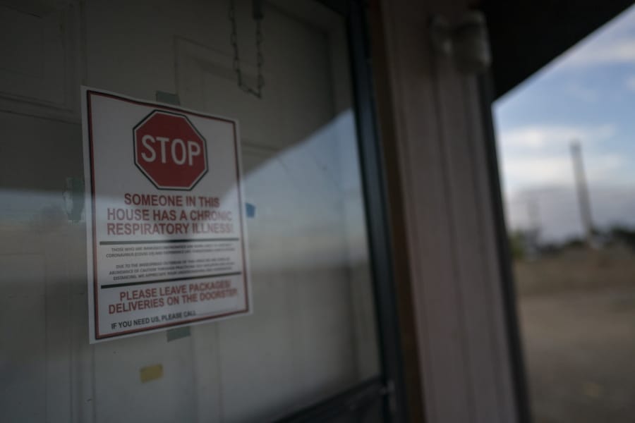 A sign is posted on the door of the hogan, a traditional Navajo dwelling, of Mabel Charley&#039;s home-bound uncle, to keep visitors out in Chilchinbeto, Ariz., on the Navajo reservation on April 21, 2020. The reservation has some of the highest rates of coronavirus in the country. If Navajos are susceptible to the virus&#039; spread in part because they are so closely knit, that&#039;s also how many believe they will beat it.