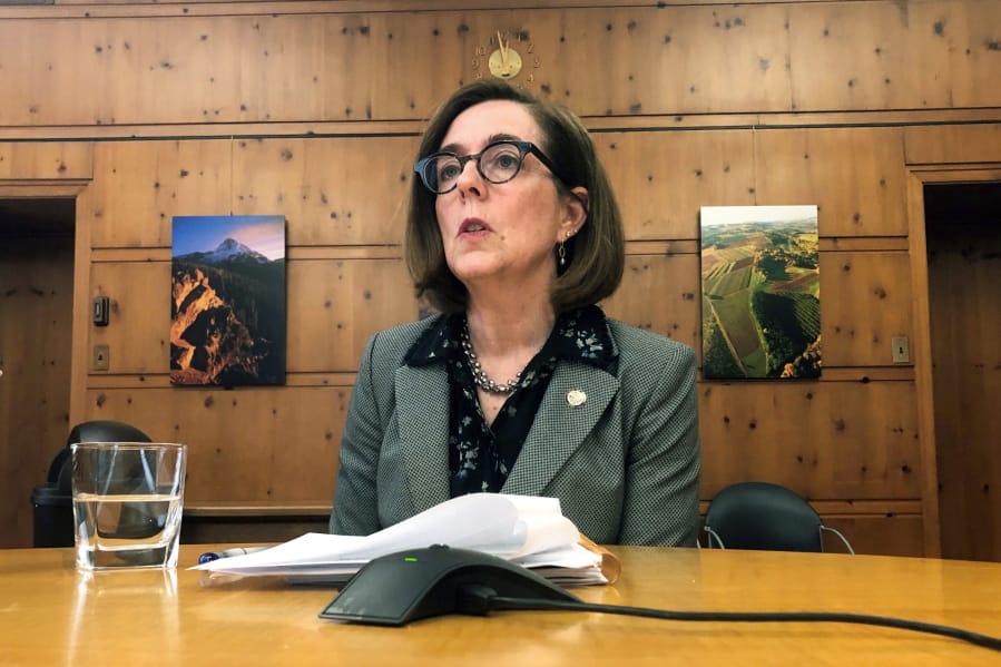 FILE - In this July 1, 2019, file photo, Oregon Gov. Kate Brown speaks with the media at the Capitol in Salem, Ore., on July 1, 2019.  A county judge has declared Oregon Gov. Kate Brown&#039;s coronavirus restrictions &quot;null and void&quot; because she didn&#039;t have her emergency orders approved by the Legislature following 28 days.