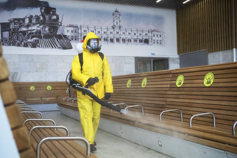 An employee of the Federal State Center for Special Risk Rescue Operations of Russia Emergency Situations disinfects a hall of Leningradsky railway station in Moscow, Russia, Tuesday, May 19, 2020. Russia has continued to see a steady rise of new infections, and new hot spots have emerged across the vast country of 147-million people that ranks the second in the world behind the United States in the number of coronavirus cases.