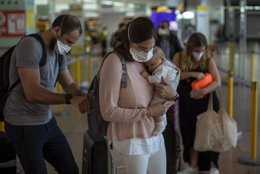 Passengers arrive at the Barcelona airport, Spain, on Friday, May 15, 2020. Travellers arriving in Spain from overseas start from Friday going into a 14-day confinement as the country takes timid steps toward re-opening borders with eyes set on reactivating the crucial tourism industry.