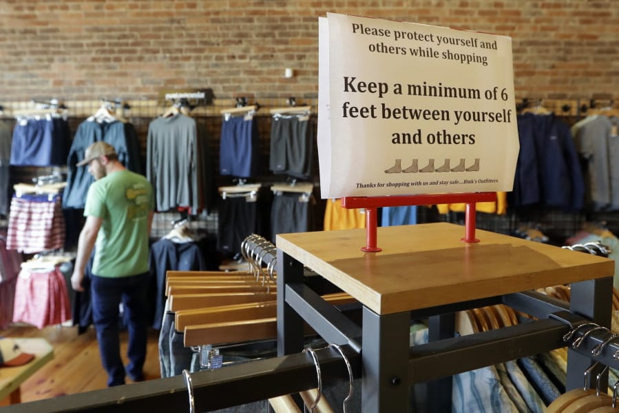 A sign reminding customers of social distancing is posted in the Bink&#039;s Outfitters store Wednesday, April 29, 2020, in Murfreesboro, Tenn. Retailers in 89 of Tennessee&#039;s 95 counties were allowed to reopen Wednesday with restrictions as the state begins the next wave of reopening its economy during the coronavirus pandemic.