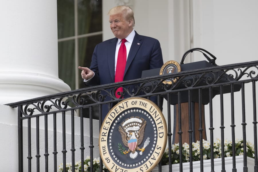 President Donald Trump points during a &quot;Rolling to Remember Ceremony,&quot; to honor the nation&#039;s veterans and POW/MIA, from the Blue Room Balcony of the White House, Friday, May 22, 2020, in Washington.