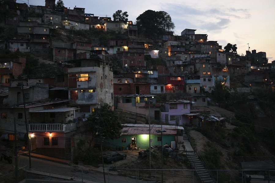 Homes cover a hill in the San Agustin neighborhood of Caracas, Venezuela, Sunday, May 17, 2020. President Nicolas Maduro is relaxing quarantine measures over the weekend by allowing children and older adults out of their homes for a few hours each day.