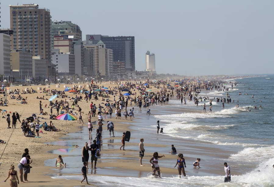 Warm weather draws crowds to the oceanfront, Saturday, May 16, 2020 in Virginia Beach, Va.