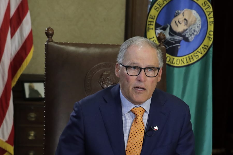 Washington Gov. Jay Inslee sits at his desk and rehearses a speech Tuesday, April 21, 2020, at the Capitol in Olympia, Wash., minutes before going live to address the public on the state&#039;s next steps in addressing the coronavirus outbreak. Inslee said the state will not be able to lift many of the stay-at-home restrictions implemented to fight the coronavirus by May 4, the date through which the existing directive is currently in place. (AP Photo/Ted S.
