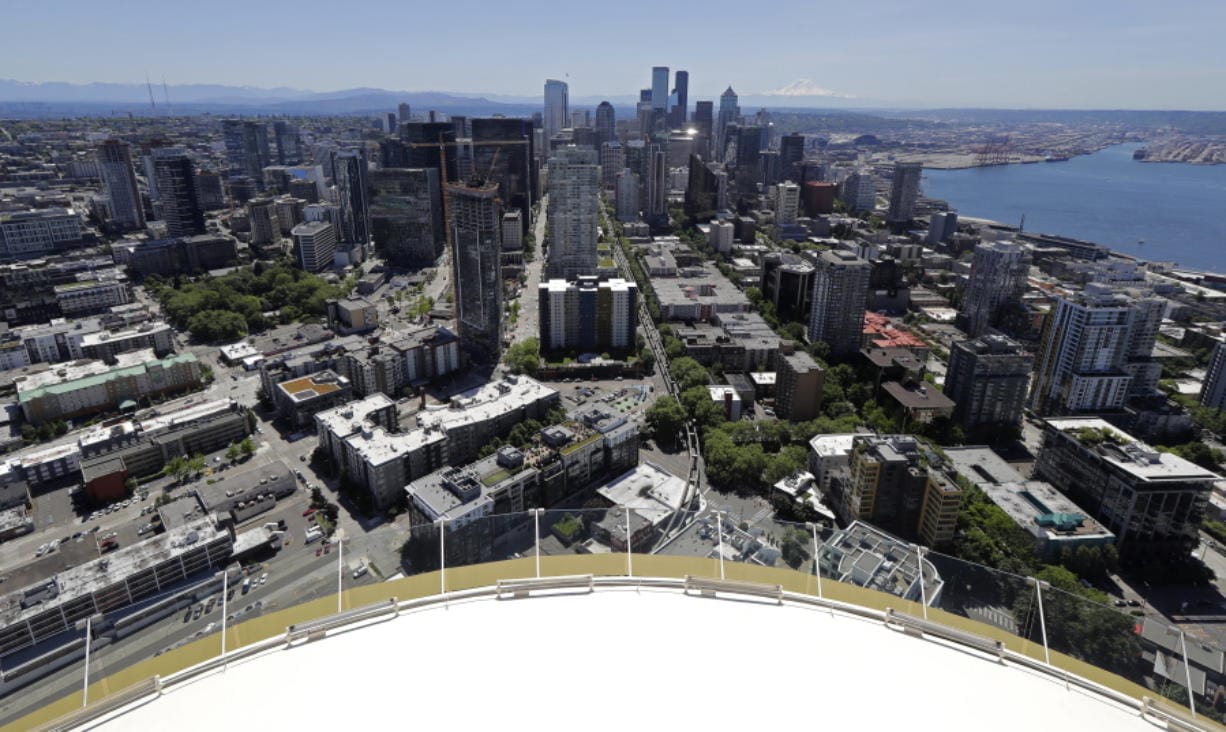 Downtown Seattle and mostly empty streets are shown, Wednesday, May 27, 2020, as viewed from the Space Needle. Many workers continue to work from home due to stay-at-home orders intended to prevent the further spread of the coronavirus. (AP Photo/Ted S.