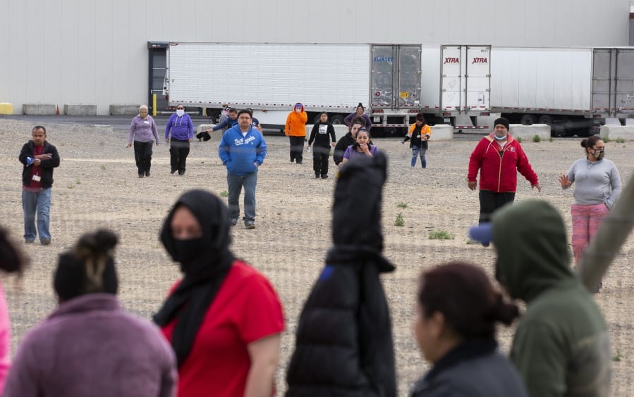 Workers from Matson Fruit Company&#039;s shipping facility walk out to join other Matson workers who were already on strike in front of the business on Tuesday, May 12, 2020 in Selah, Wash. Workers want to get several demands met, including hazard pay.