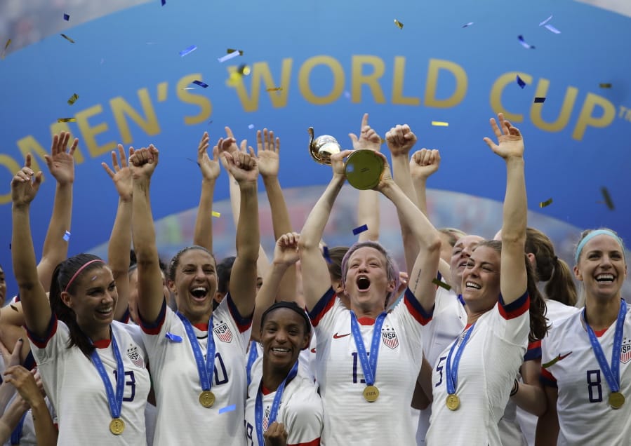 United States&#039; Megan Rapinoe lifts up the trophy after winning the Women&#039;s World Cup final last summer.