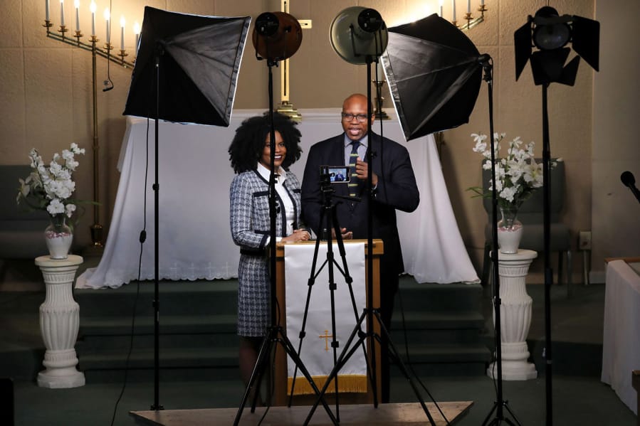 The Rev. Craig Robinson and his wife, associate pastor Dr. Shakira Sanchez-Collins, film their Sunday service at St. James AME Church in Chicago on May 7, 2020.