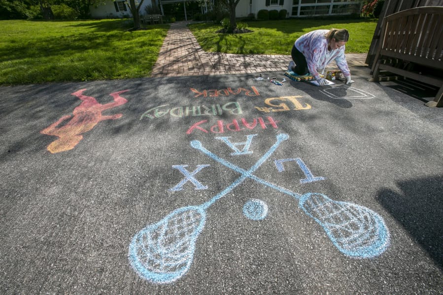 Stefanie Heron-Birl, former face painter, now chalk drawer because of social distancing, creates a drawing on the driveway of Kate Semon&#039;s house on Allerton Road in West Chester, Pa. This drawing is for Radek Semon to help celebrate his 15th birthday. (Alejandro A.