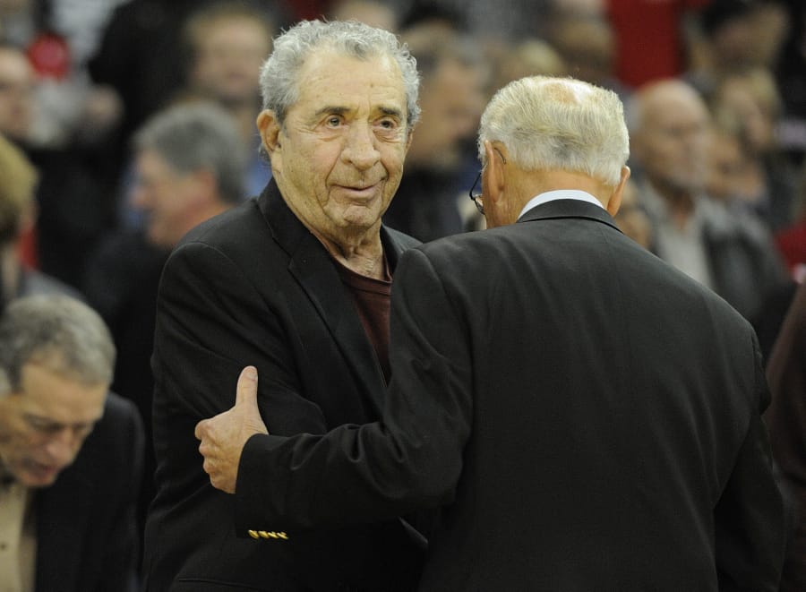 Former Trail Blazer president Harry Glickman, left, embraces Bill Shonley, right, during ceremonies before the start of a game between the Portland Trail Blazers and the Phoenix Suns at Memorial Coliseum in Portland, Oregon Wednesday October 14, 2009.
