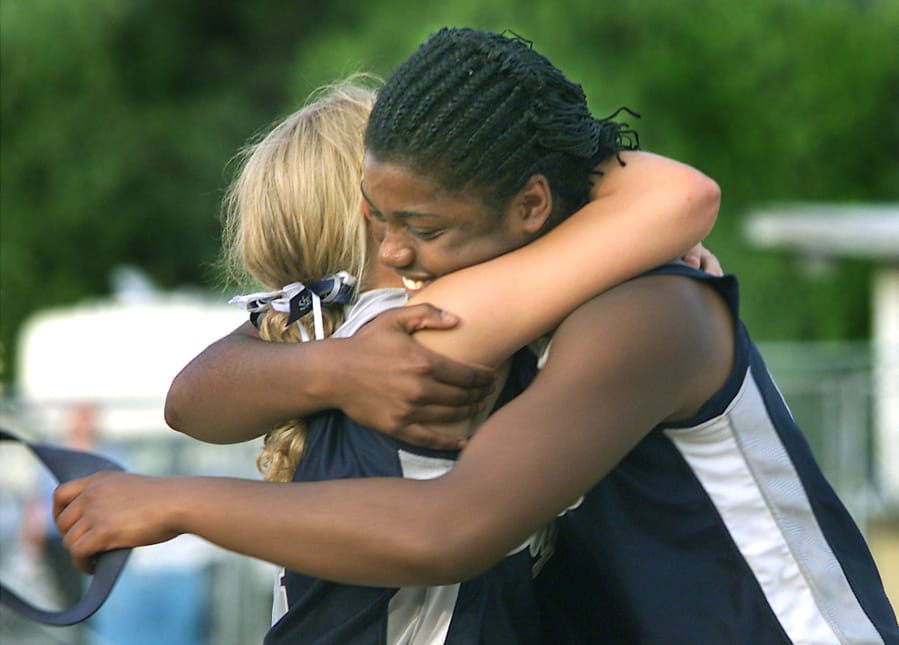 Skyview's Kara Lefebvre hugs winning pitcher Chemil Washington after the Storm beat W.F. West 3-2 in 8 innings for the 2001 3A state championship.