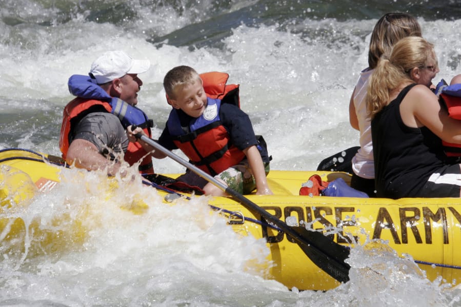 Tanner Myers of Lisbon, N.D., and Jon Hauf of Lisbon raft the Boise River in June 2008 on the opening day of the float season.