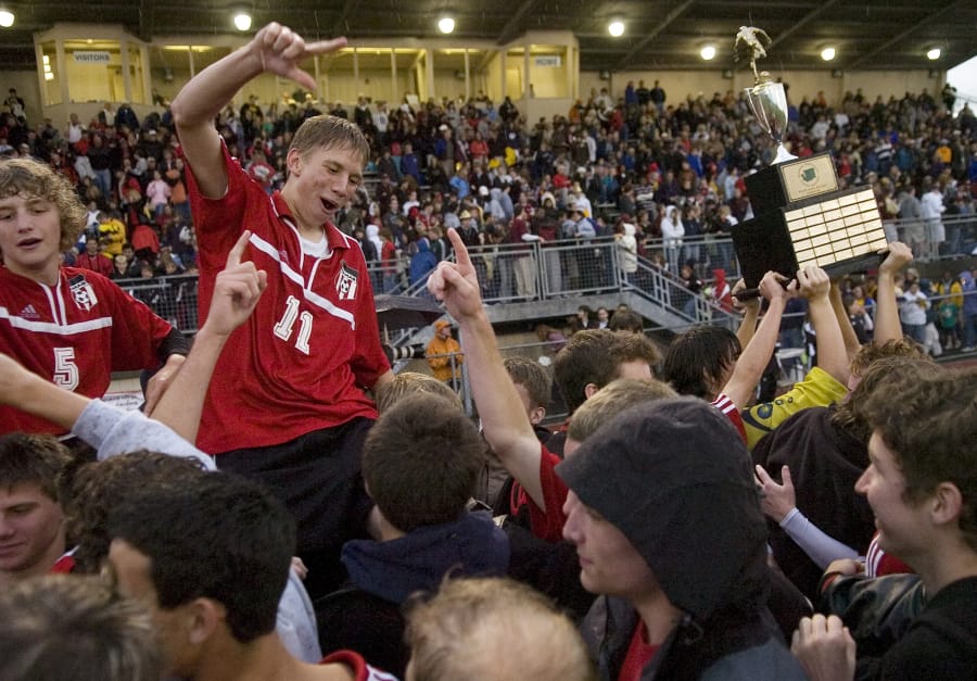 Camas players Billy Keyser, left, and Jason Martschinske, celebrate with fans after winning the 3A boys state soccer championship on May 27, 2006, at Sumner.
