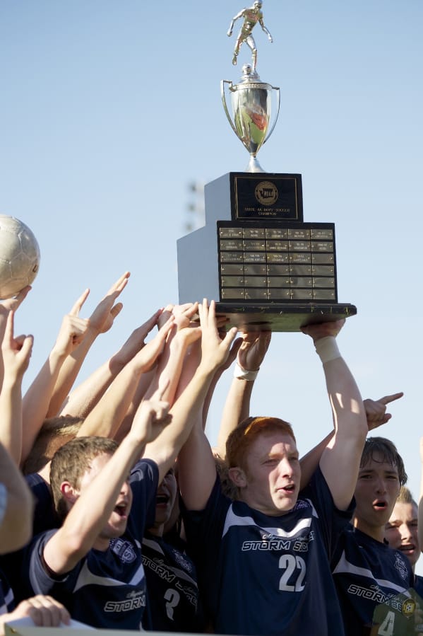 Skyview's Hayden Schuh, center, and teammates hoist the boys 4A state soccer championship trophy on May 26, 2012 at Puyallup. Skyview beat Central Kitsap 3-2.