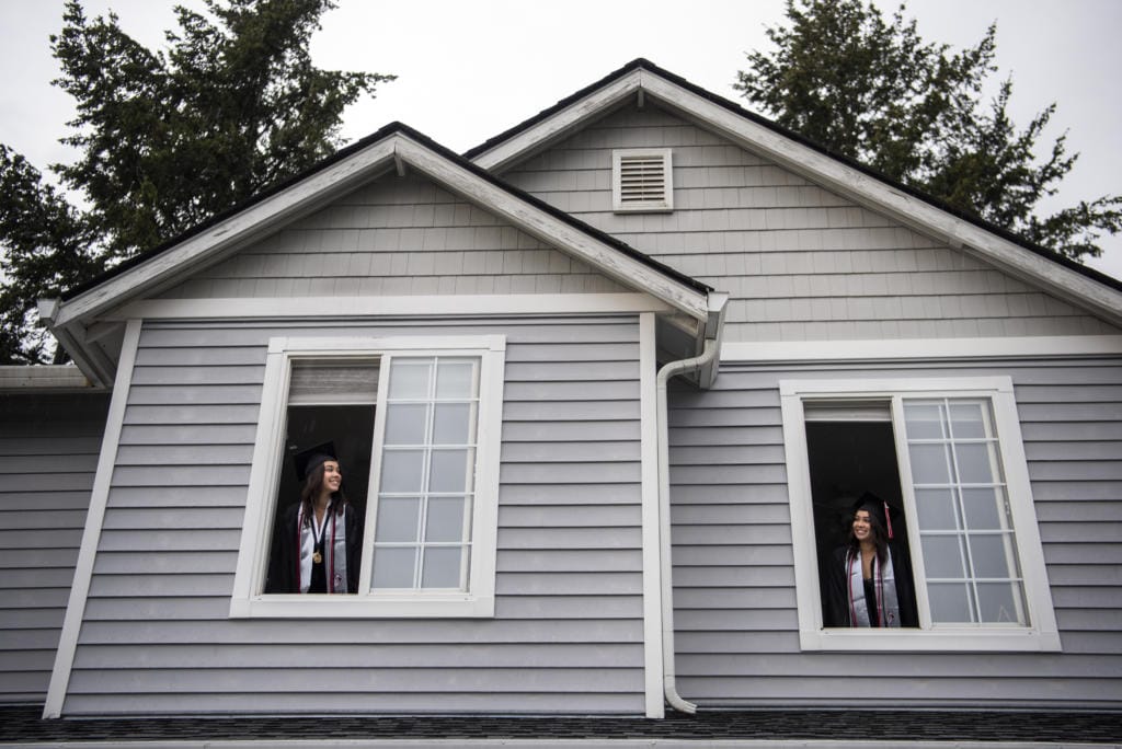 Union High School seniors Lauryn Lopez, left, and her twin sister Ashtyn look out the windows of their Vancouver home.