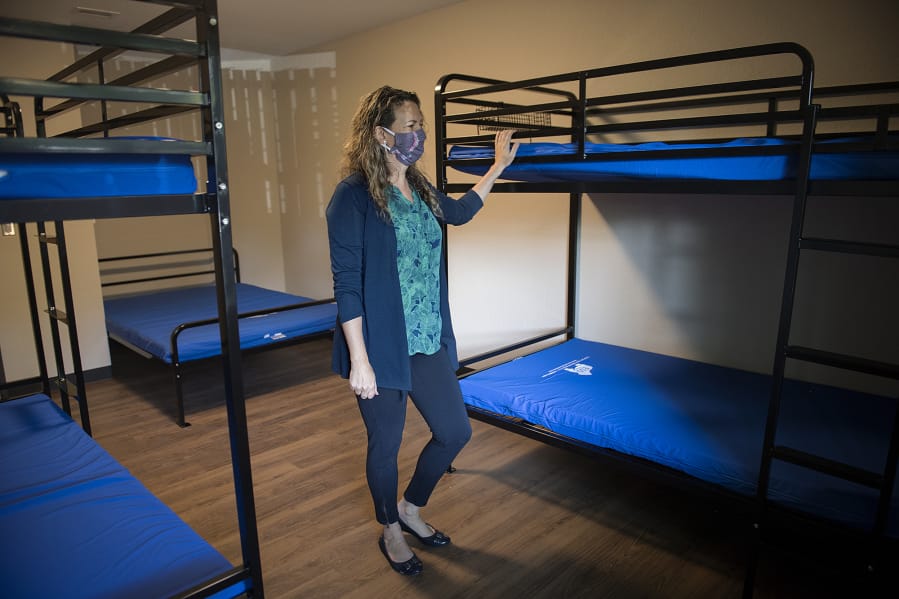 Amy Reynolds, deputy director of Share, looks over one of the newly renovated rooms at Share Orchards Inn. The shelter received new metal bed frames to help prevent bed bugs, which have been an issue in the past.