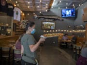 In Phase 2, restaurants in Clark County can open indoor dining but servers must wear masks.