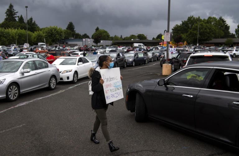 Jaylah Morton of Vancouver, 17, helps direct traffic as cars line up for &quot;Car Rally For Black Lives,&quot; which started at the Town Plaza Center in Vancouver on Saturday. &quot;It makes me feel good that people are finally coming together and it&#039;s not just Black people, it&#039;s everybody,&quot; she said.