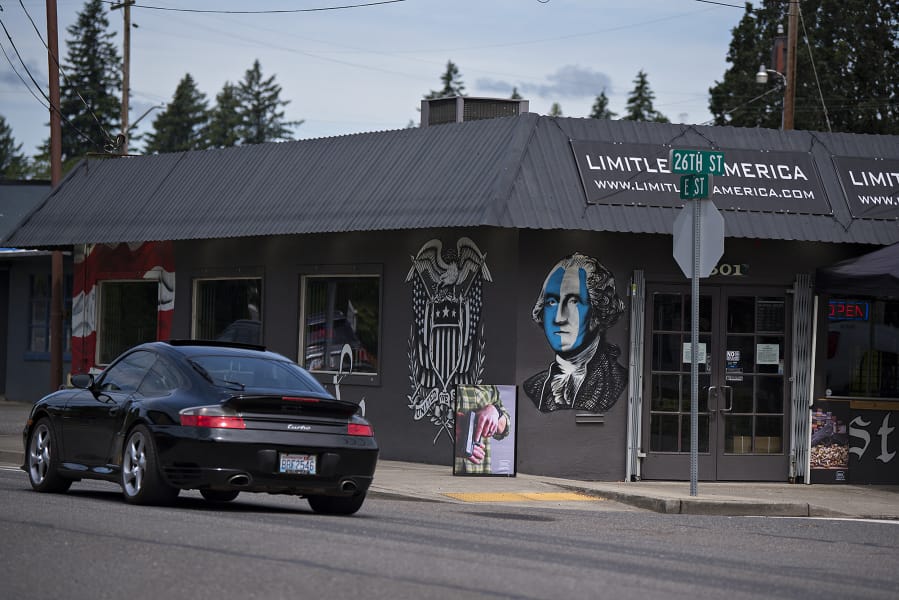 A motorist drives past Limitless America, a firearm retailer in Washougal, on Thursday morning. Photos circulating on social media of an armed group outside of Limitless America during a rally for black lives Sunday drew a number of concerns from community members.