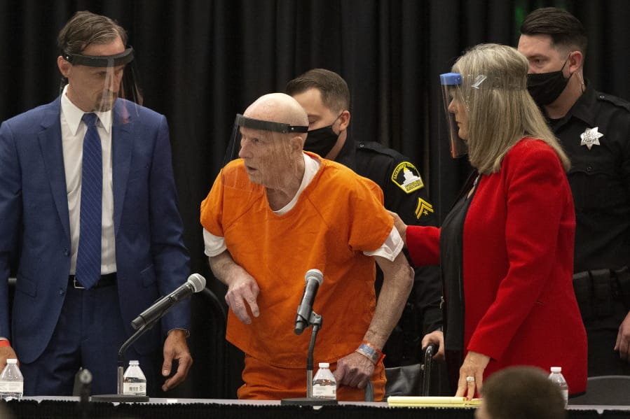 Joseph James DeAngelo, center, charged with being the Golden State Killer, is helped up by his attorney, Diane Howard, as Sacramento Superior Court Judge Michael Bowman enters the courtroom in Sacramento, Calif., Monday June 29, 2020. DeAngelo pleaded guilty to multiple counts of murder and other charges 40 years after a sadistic series of assaults and slayings in California. Due to the large numbers of people attending, the hearing was held at a ballroom at California State University, Sacramento to allow for social distancing.