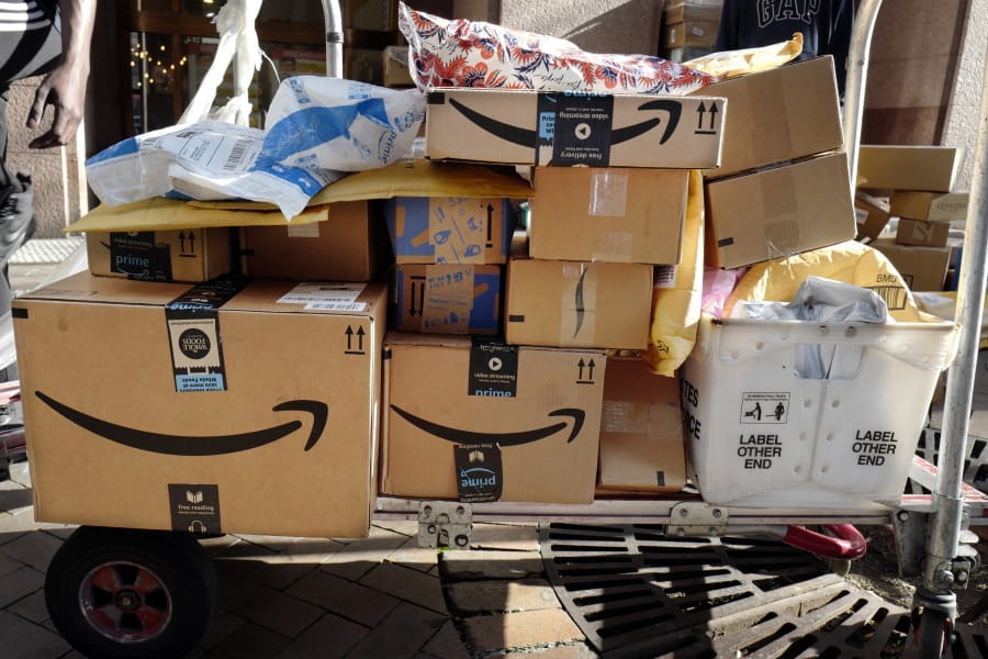 FILE - In this Oct. 10, 2018, file photo, Amazon Prime boxes are loaded on a cart for delivery in New York. Amazon said Tuesday, June 23, 2020, that its carbon footprint rose 15% last year, even as it launched initiatives to reduce its harm on the environment.