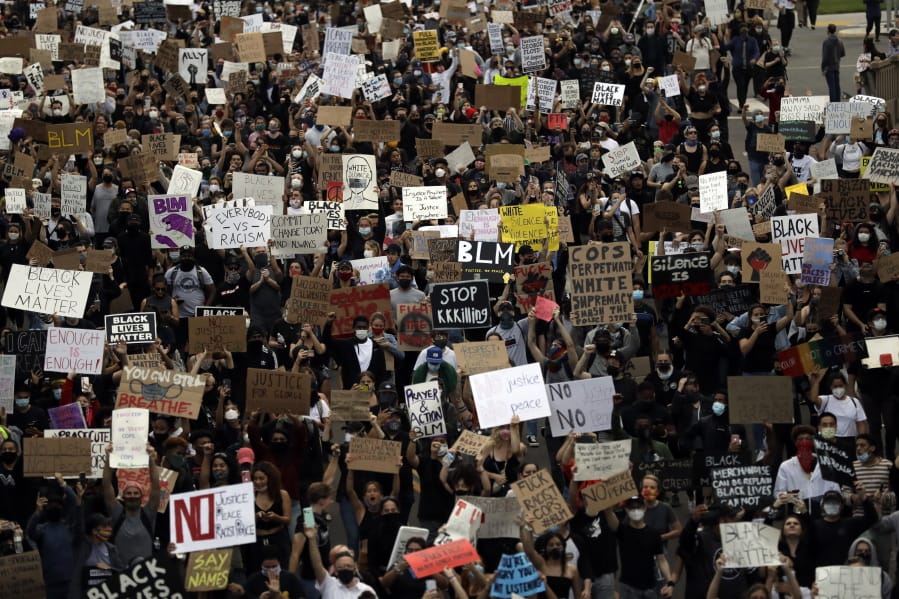 Protesters march Thursday, June 4, 2020, in San Diego. Protests continue to be held in U.S. cities, sparked by the death of George Floyd, a black man who died after being restrained by Minneapolis police officers on May 25.