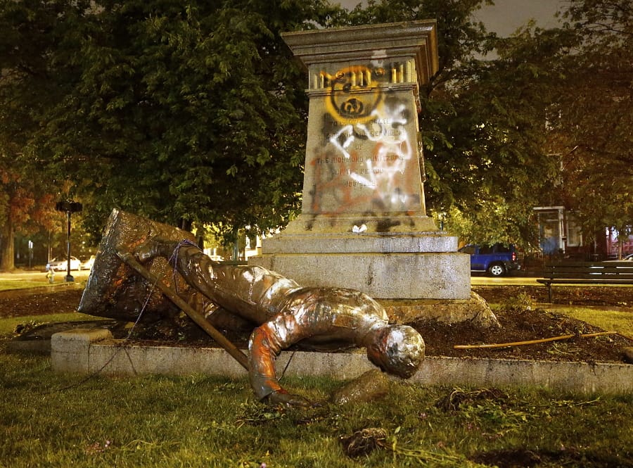 A statue from the Richmond Howitzers Monument in Richmond, Va., lies after being toppled Tuesday night, June 16, 2020, in Richmond, Va.