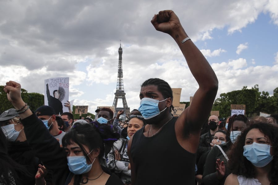 Hundreds of demonstrators gather on the Champs de Mars as the Eiffel Tower is seen in the background during a demonstration in Paris, France, Saturday, June 6, 2020, to protest against the recent killing of George Floyd, a black man who died in police custody in Minneapolis, U.S.A., after being restrained by police officers on May 25, 2020.