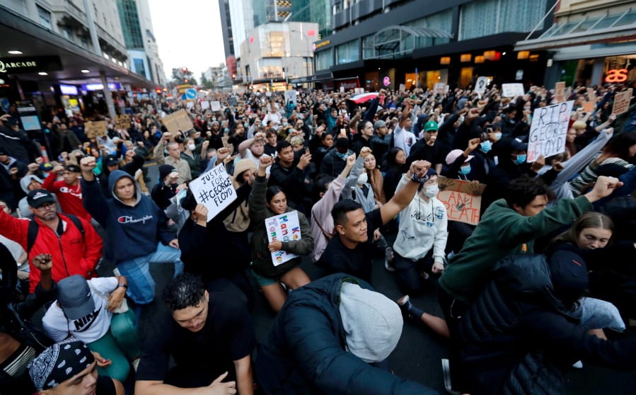 Demonstrators hold placards during a march in central Auckland, New Zealand, Monday, June 1. 2020, to protest the death of United States&#039; George Floyd, a black man who died in police custody in Minneapolis on May 25. Floyd, who after a white police officer who is now charged with murder, Derek Chauvin, pressed his knee into Floyd&#039;s neck for several minutes even after he stopped moving and pleading for air.