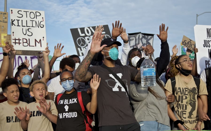 Portland Trail Blazers&#039; Damian Lillard, center, joins other demonstrators in Portland, Ore., during a protest against police brutality and racism, sparked by the death of George Floyd, who died May 25 after being restrained by police in Minneapolis.
