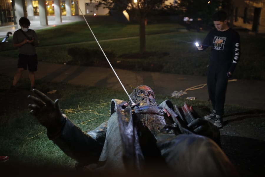 People film the only statue of a Confederate general, Albert Pike, in the nation&#039;s capital after it was toppled by protesters and set on fire in Washington early Saturday, June 20, 2020.