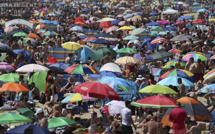 Crowds gather on the beach in Bournemouth, England, Thursday June 25, 2020, as coronavirus lockdown restrictions have been relaxed. According to weather forecasters Thursday could be the UK&#039;s hottest day of the year, so far, with scorching temperatures forecast to rise even further.