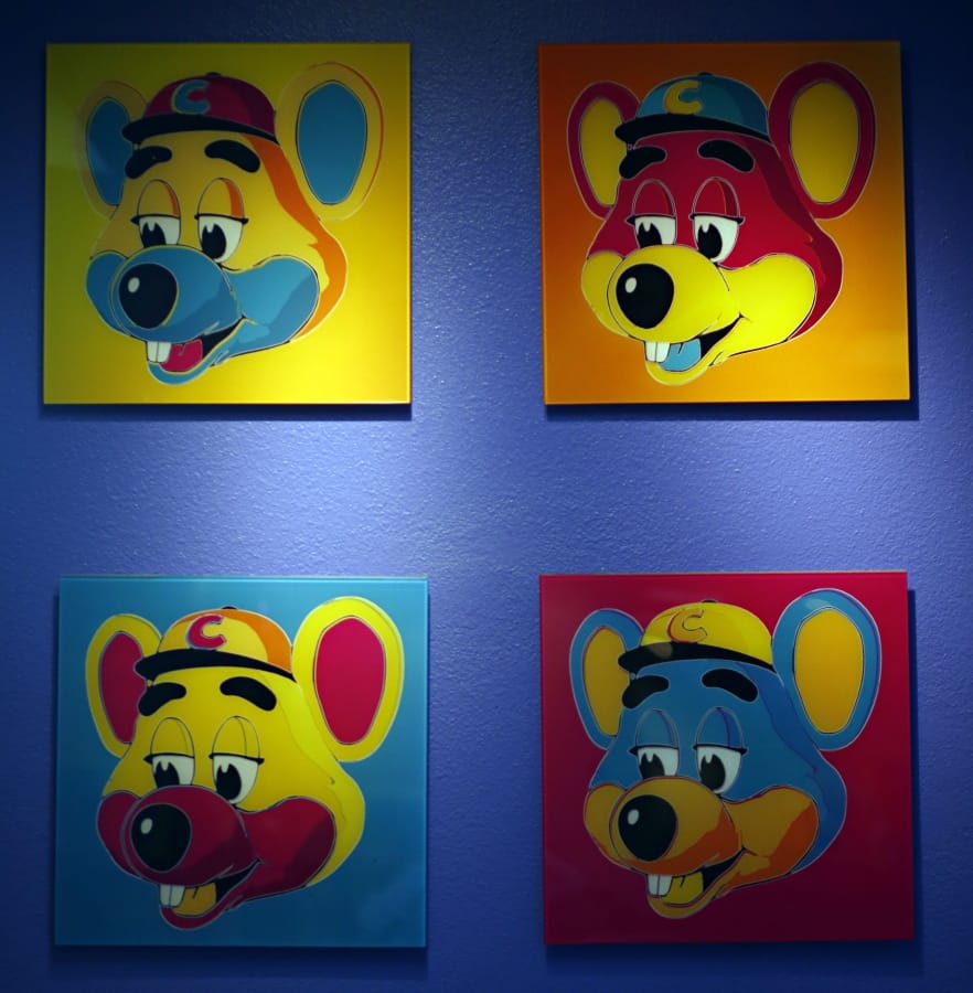FILE - This Jan. 16, 2014 file photo shows paintings hanging  on a wall at Chuck E. Cheese&#039;s in Dallas. Chuck E. Cheese pizzeria, that Mecca of fun for children but the bane of many parents, is filing for bankruptcy protection. CEC Entertainment Inc. said Thursday, Jan. 25, 2020,  it was filing for voluntary protection under Chapter 11 &quot;in order to overcome the financial strain resulting from prolonged, COVID-19 related venue closures.&quot;  (G.J.