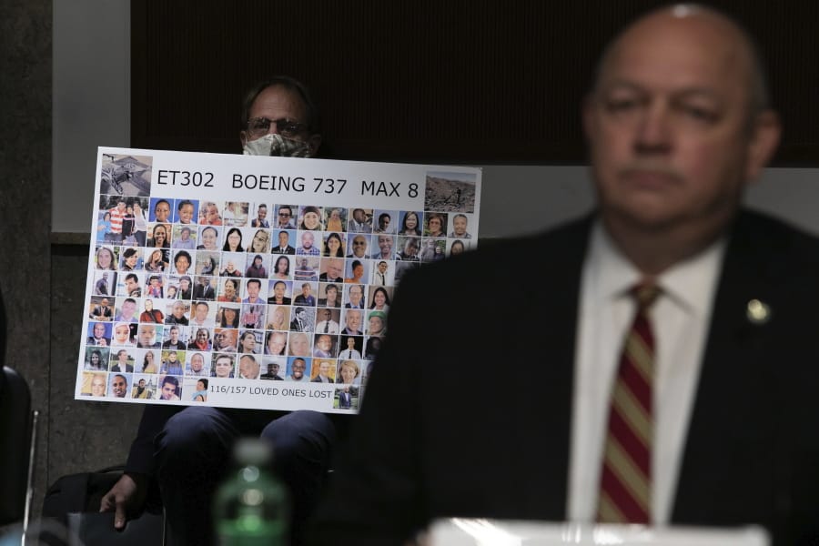 Michael Stumo holds a sign displaying photographs of the individuals who were killed in the March 10, 2019, crash of Ethiopian Airlines flight 302, as Federal Aviation Administration administrator Stephen Dickson testifies during a hearing of the Senate Commerce, Science, and Transportation Committee on Capitol Hill on Wednesday, June 17, 2020, in Washington.
